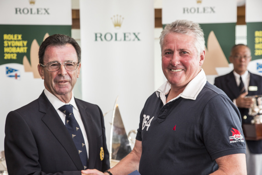 Chris Bran, Brannew, accepts the trophy for placing second IRC Division 3, from CYCA Commodore Howard Piggott