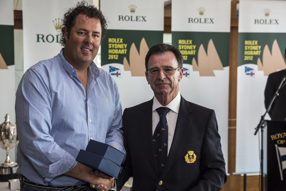 Jason Van der Slot accepts the Apollo Trophy for the first yacht under 18.5m across the finish line