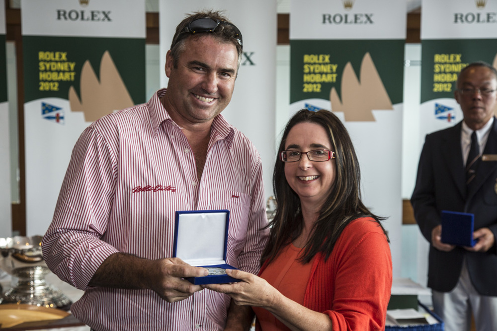 John Hildebrand accepts Steve Jarvin's 25 Hobart medallion from the Hon. Michelle O'Byrne
