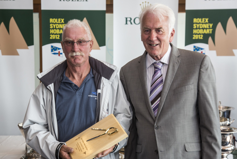 Phil Brassington, navigator of Cougar II, accepts the City of Hobart trophy for the Navigator of the first Tasmanian yacht on corrected time, from Damon Thomas, Lord Mayor of Hobart