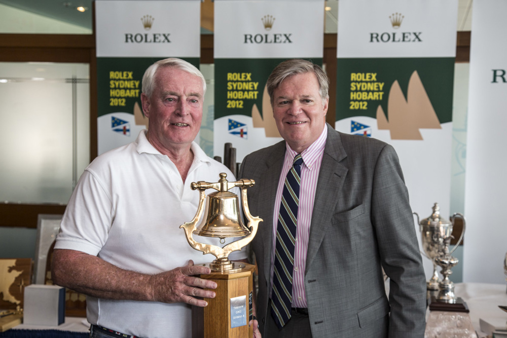 Lindsay May, navigator, Love & War, accepts the Tasports trophy for first ORCi Div 3, from Paul Weedon, Chairman, TasPorts