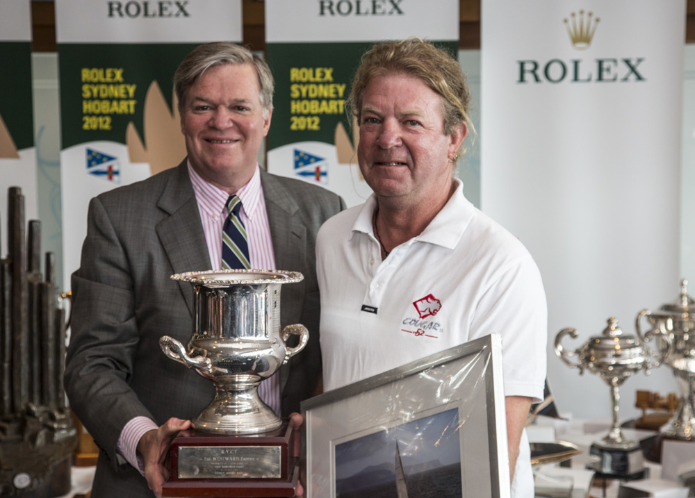 Anthony Lyall, owner of Cougar II, accepts the Tasport Trophy for the first Tasmanian boat on IRC, from Paul Weedon, Chairman, TasPorts