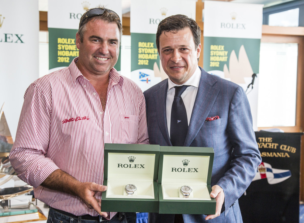 John Hildebrand, Wild Oats XI, is presented with two Rolex Yacht-Master timepieces, for Wild Oats XI's line honours and overall win, by Patrick Boutellier, General Manager, Rolex Australia