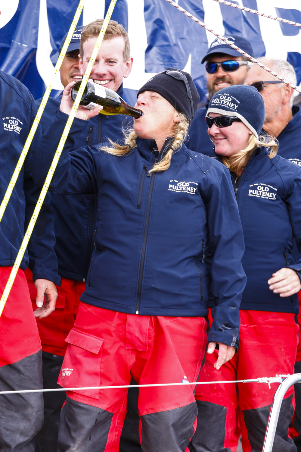 The Old Pulteney crew celebrate dockside at the end of the Clipper Round the World race, a category of the Sydney to Hobart yacht race at Constitution Dock in Hobart, Monday, Dec. 30, 2013. (AAP Image/Heath Holden) NO ARCHIVING, EDITORIAL USE ONLY