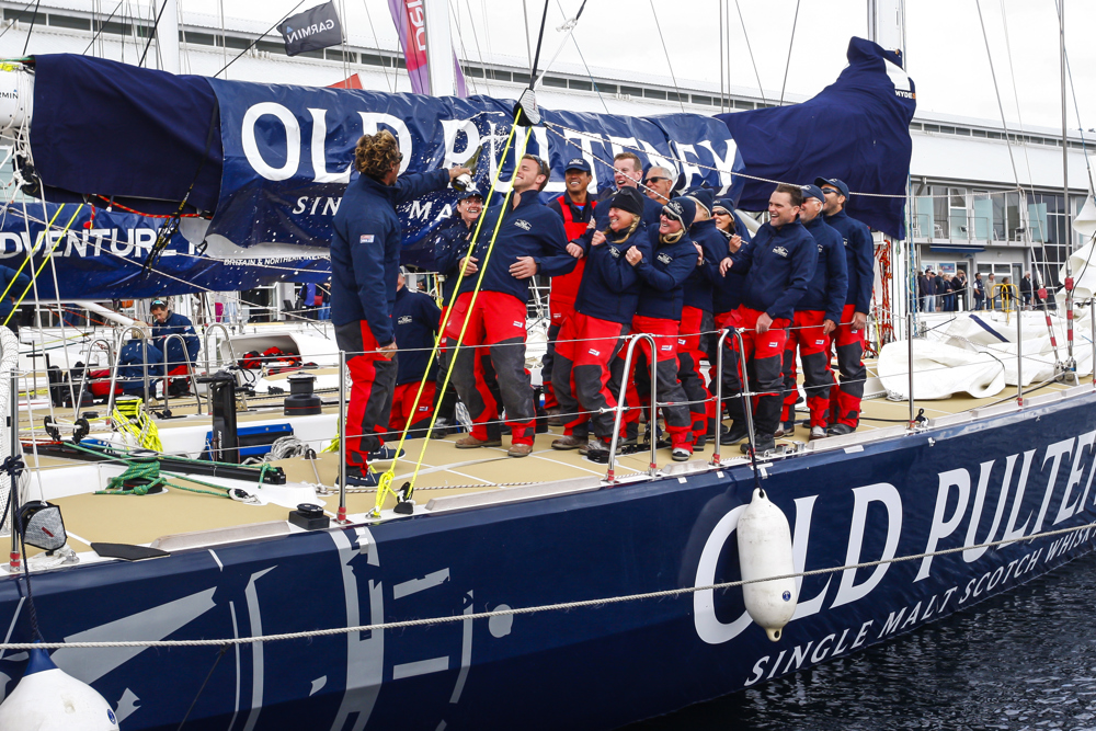 The Old Pulteney crew celebrate dockside at the end of the Clipper Round the World race, a category of the Sydney to Hobart yacht race at Constitution Dock in Hobart, Monday, Dec. 30, 2013. (AAP Image/Heath Holden) NO ARCHIVING, EDITORIAL USE ONLY