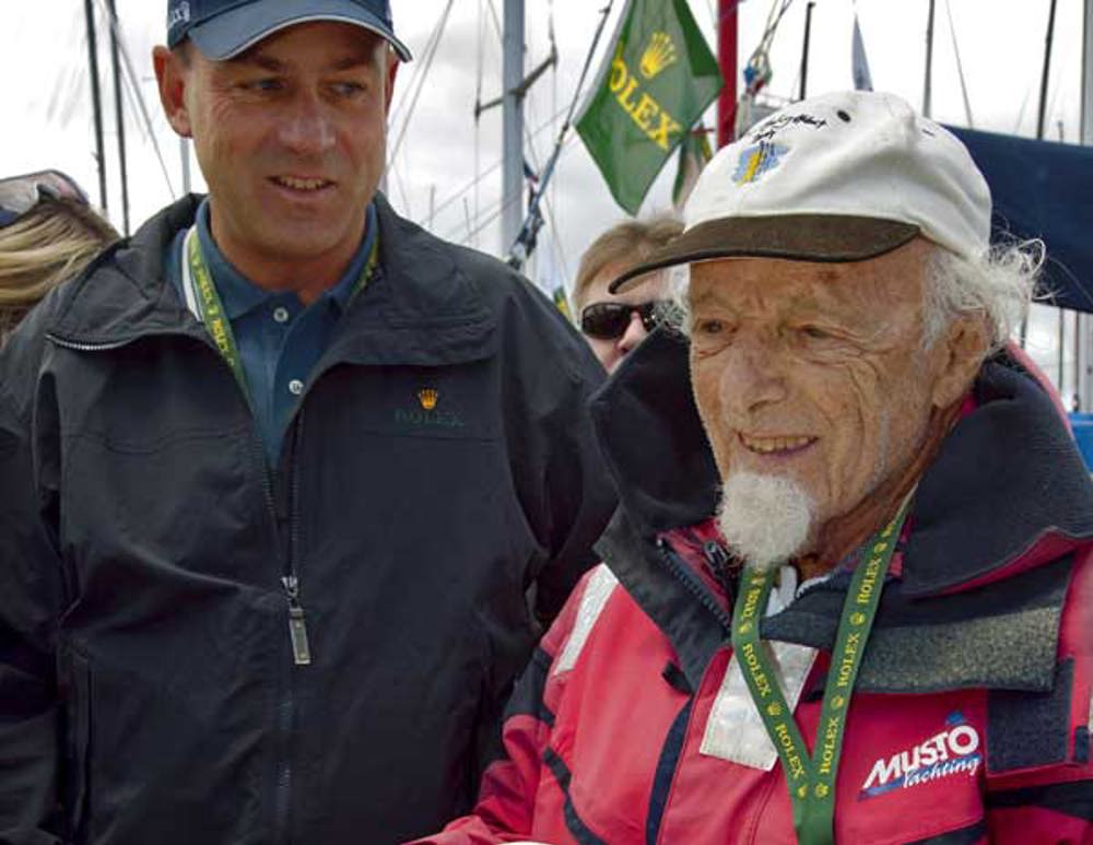 John Walker, the oldest skipper at 86 in the Rolex Sydney Hobart 2008, being presented with a cake to mark his 25th Hobart for himself and his boat