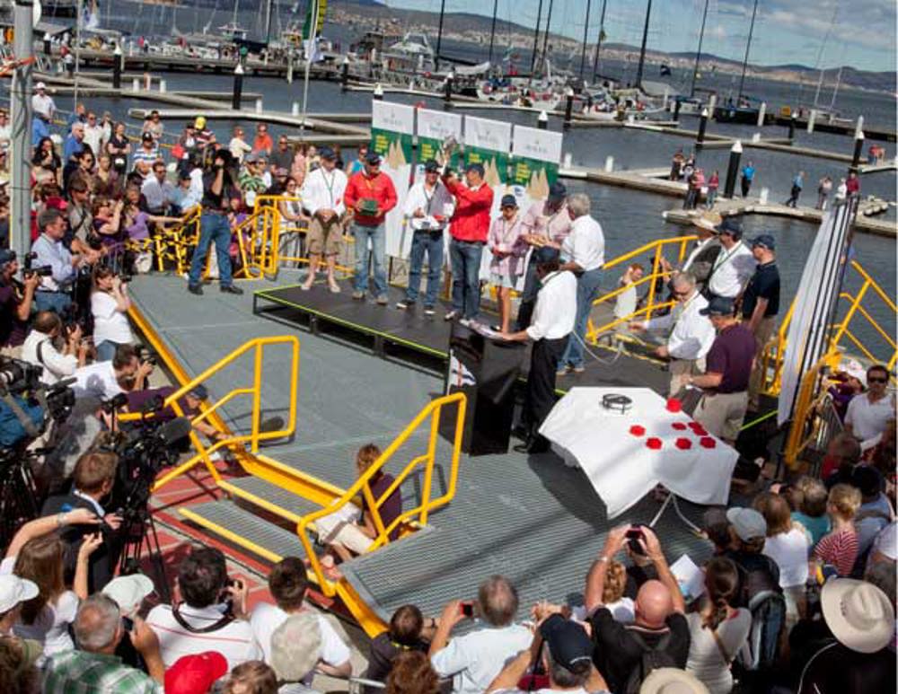 Wild Oats XI crew accept the Illingworth Trophy for their line honours win on Constitution Dock