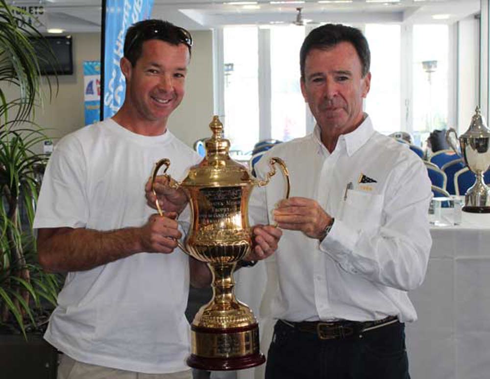 Darren Senogles accepts the overall winners trophy, on behalf of Loki's owner Stephen Ainsworth, from Commodore Howard Piggott