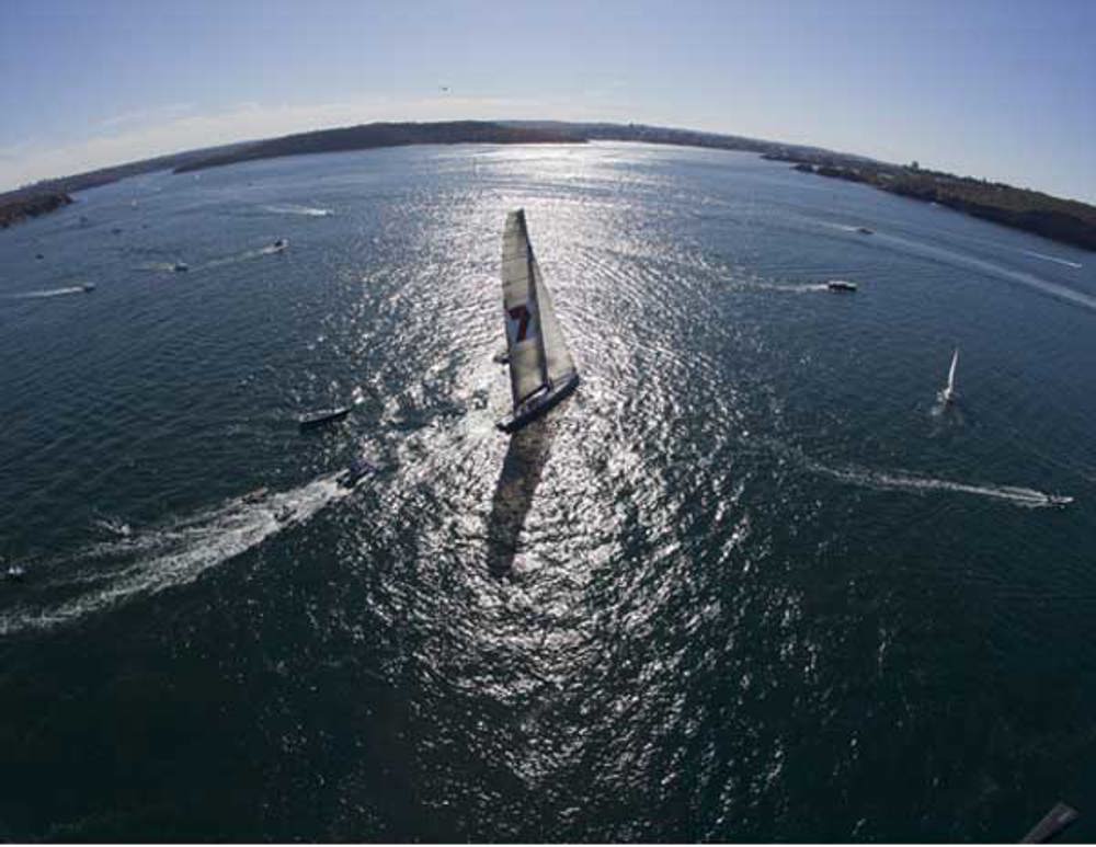 Wild Oats XI leaving Sydney Harbour with some spectators in her wake
