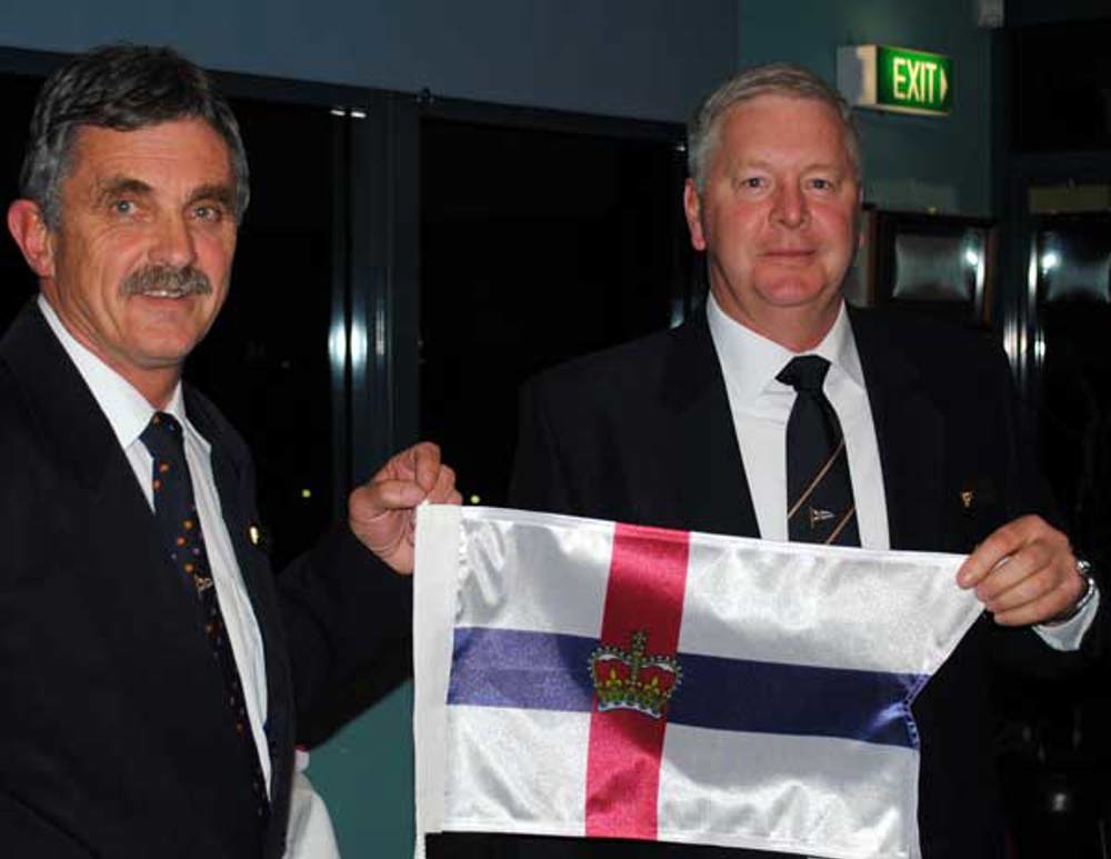 Immediate Past Commodore Clive Simpson presenting newly elected RYCT Commodore Graham Taplin with his burgee