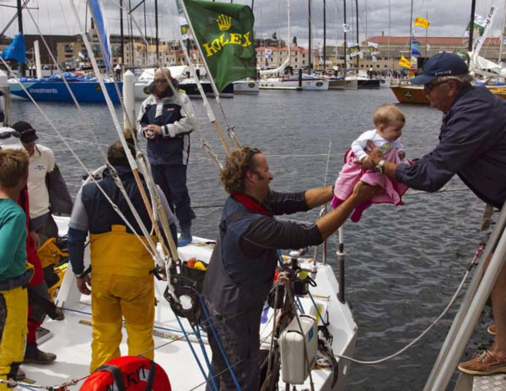 Bill Wells, crew member of Telcoinabox Merit, greets his daughter Lucy on arrival in Hobart
