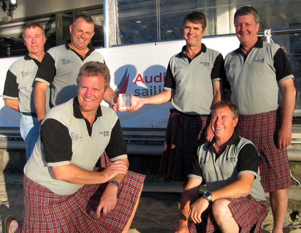 Tartan crew accepted their PHS Division 2 trophy in their clan tartan kilts at the prizegiving for the Audi Sydney Gold Coast Yacht Race