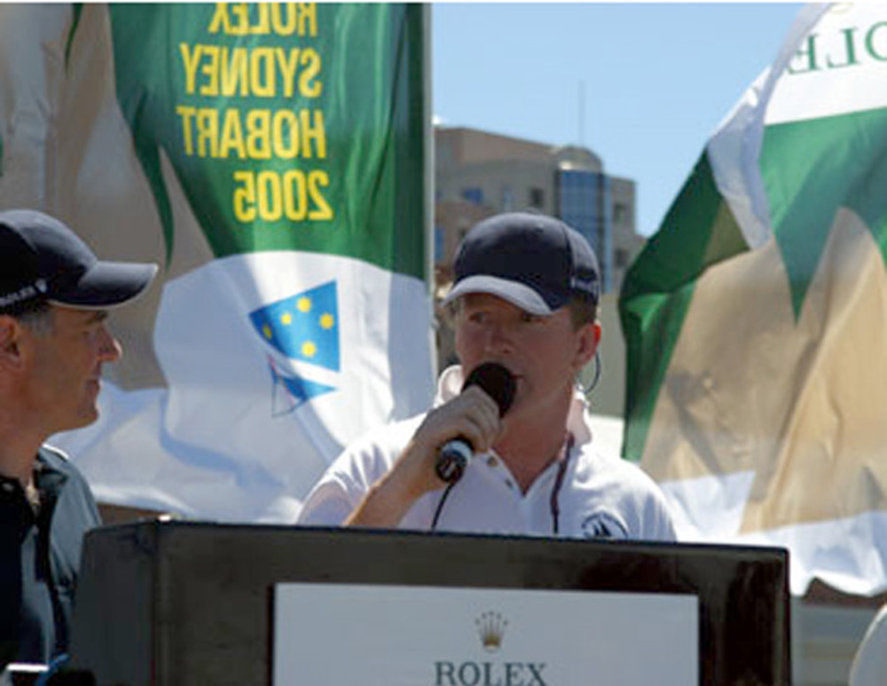 Gerard O'Rourke, skipper of Chieftain, accepting the divisional winner's battle flag at the dockside presentation for winning IRC Division B