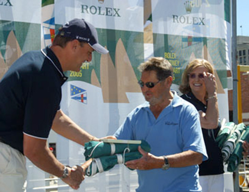 Lou Abrahams, skipper of Challenge, accepts the divisional winners battle flags from Matteo Mazzanti of Rolex