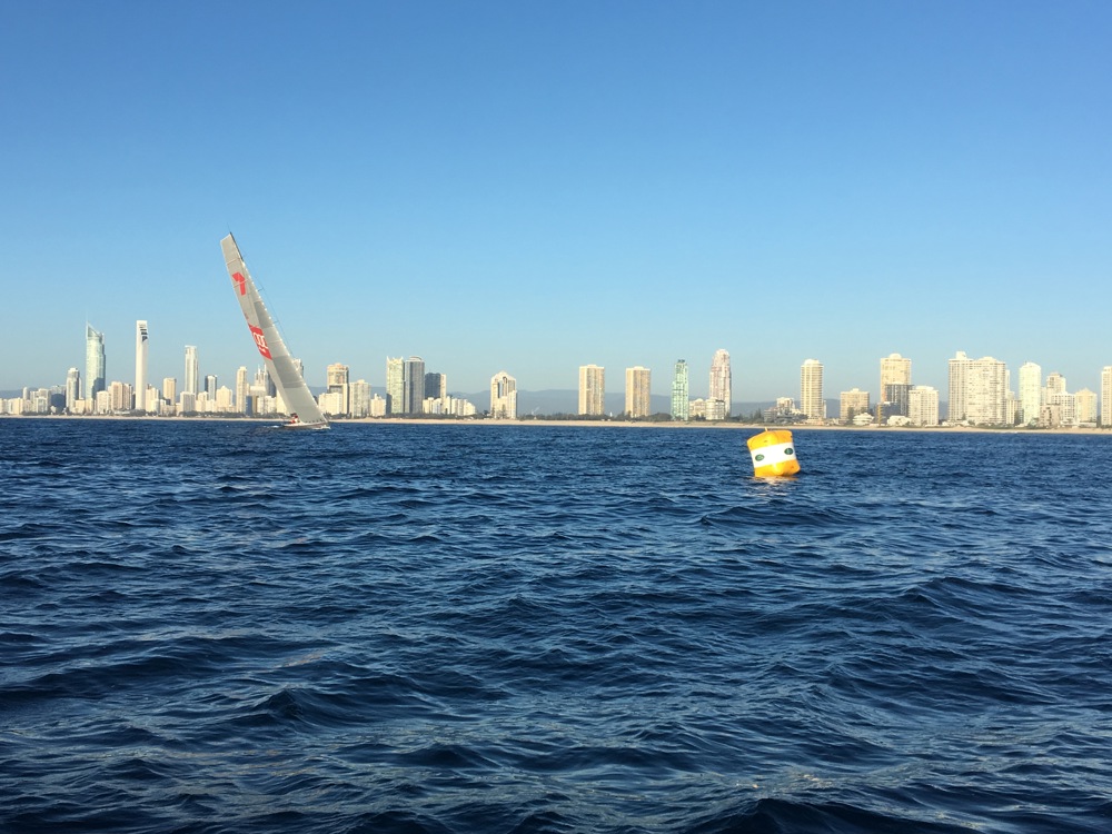Wild Oats XI approaches the finish line, with the Gold Coast in the background