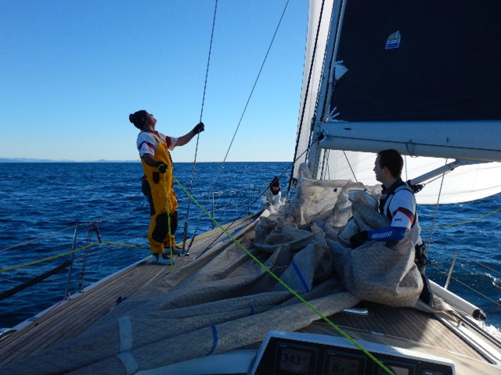 Flaking the genoa after an early morning sail change on Wax Lyrical