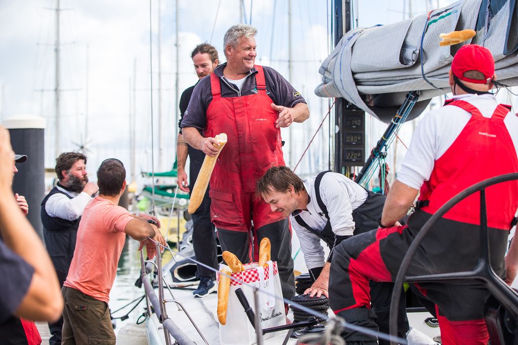 Frantic skipper Mick Martin breaking bread with his winning team at the dock on Noumea