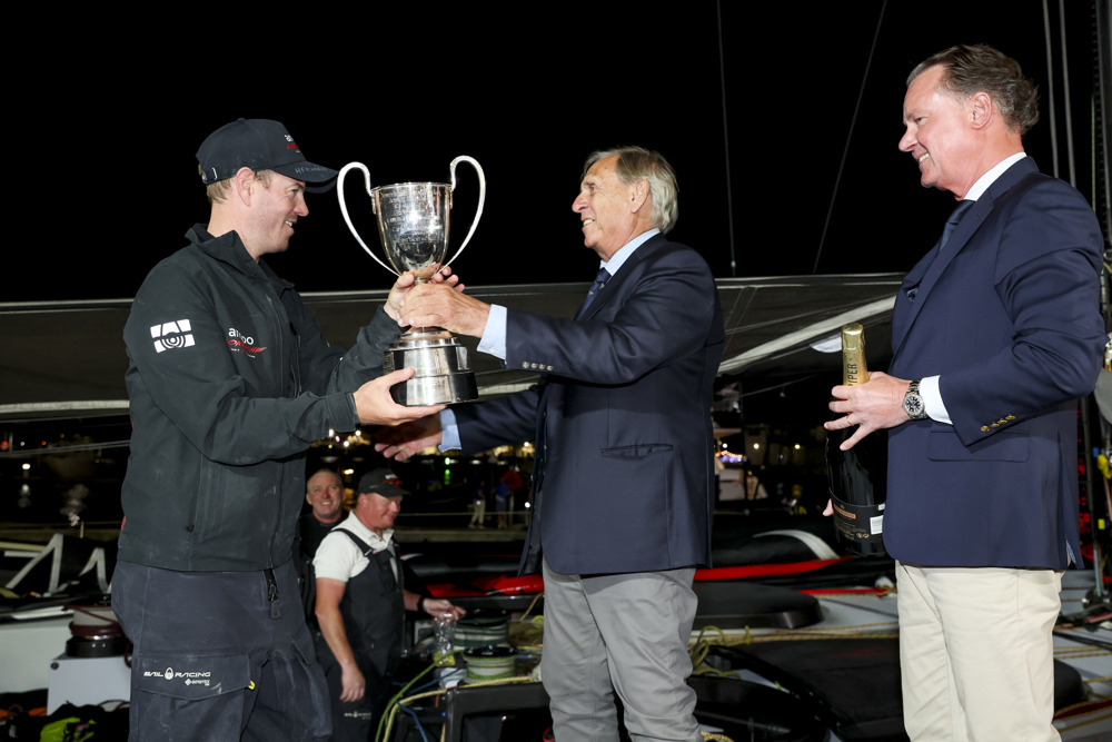 Commodore Arthur Lane presents the Illingworth Cup to Andoo Comanche skipper John Winning Jr.