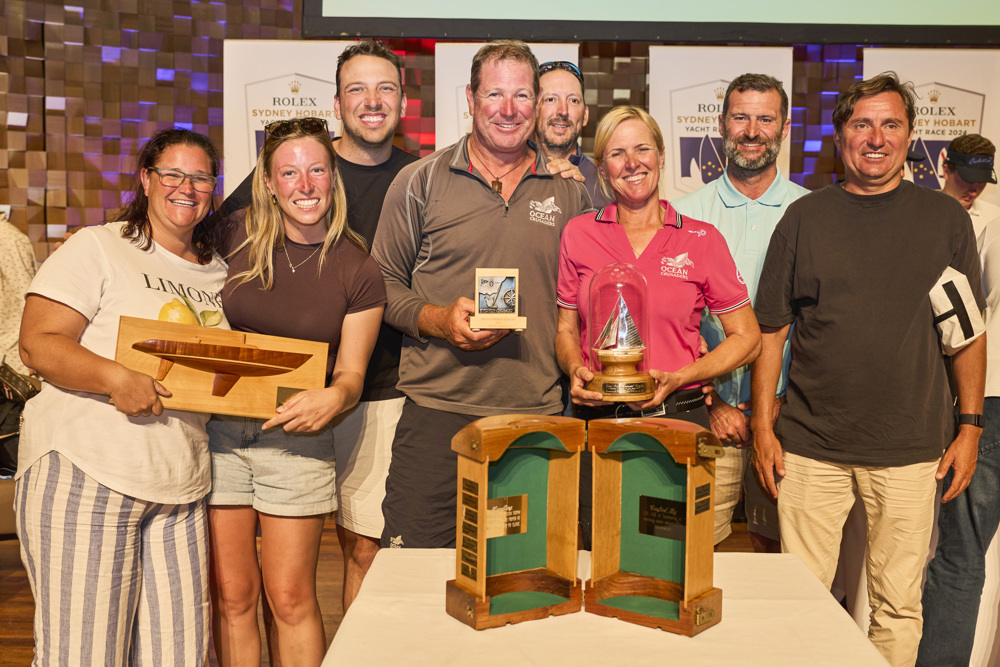 Annika Thomson, winner of the Jane Tate Memorial Trophy for 1st Female Skipper over the line, with co-owner Ian Thomson and crew of Ocean Crusaders J-Bird, celebrating with their trophies.    