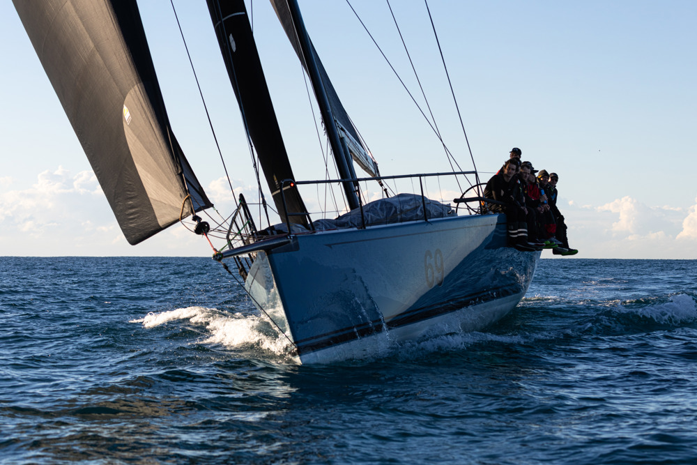 Smuggler enjoying the flat water and land breeze as it approaches the finish.     Image: CYCA | Ashley Dart
