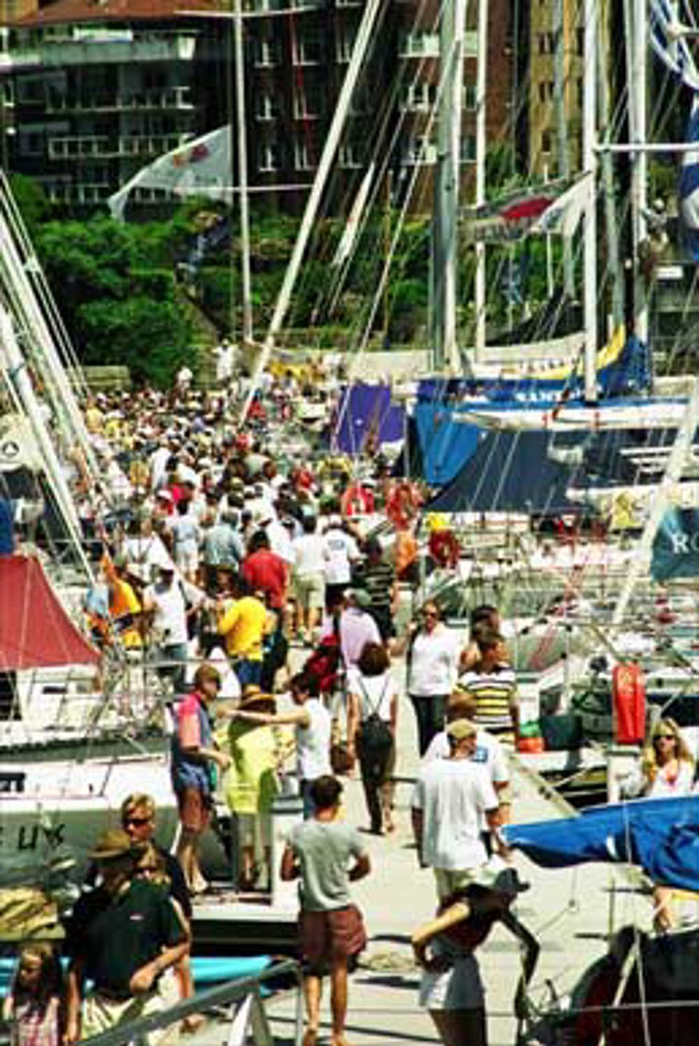 Spectators and crew crowd the marina on race morning