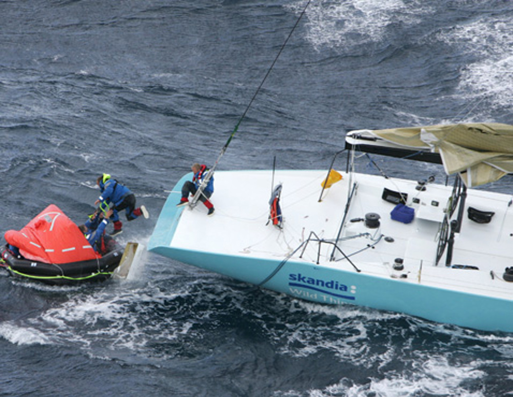 Skandia crew jumping into a liferaft