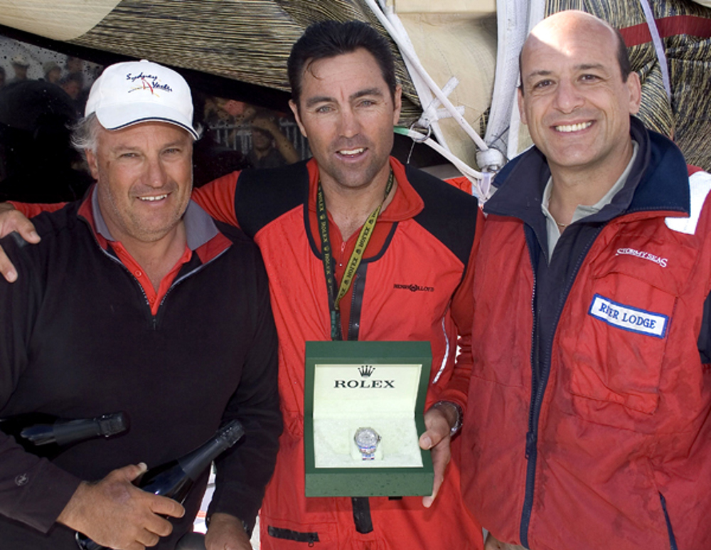 Iain Murray and Mark Richards from the line honours boat Wild Oats XI are presented with a Rolex watch by Matteo Mazzanti from Rolex SA