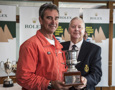 A crew member from Lahana collects the trophy for being third over the line from RYCT Commodore Graham Taplin