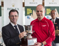 A crew member from Ambersail collects the Polish Trophy for the yacht travelling from the furthest point to compete