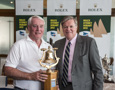Lindsay May, navigator, Love & War, accepts the Tasports trophy for first ORCi Div 3, from Paul Weedon, Chairman, TasPorts