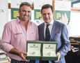 John Hildebrand, Wild Oats XI, is presented with two Rolex Yacht-Master timepieces, for Wild Oats XI's line honours and overall win, by Patrick Boutellier, General Manager, Rolex Australia
