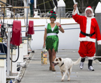 Santa and his elf walk the docks of the CYCA