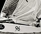 Crew members onboard Vamp take down the spinnaker near the Organ Pipes