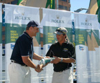 Mike Freebairn, skipper of Ray White Koomooloo, accepts the divisional winners battle flag from Matteo Mazzanti of Rolex