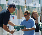 Lou Abrahams, skipper of Challenge, accepts the divisional winners battle flags from Matteo Mazzanti of Rolex