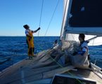 Flaking the genoa after an early morning sail change on Wax Lyrical