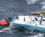 Skandia crew jumping into a liferaft