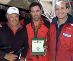 Iain Murray and Mark Richards from the line honours boat Wild Oats XI are presented with a Rolex watch by Matteo Mazzanti from Rolex SA
