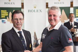 Chris Bran, Brannew, accepts the trophy for placing second IRC Division 3, from CYCA Commodore Howard Piggott