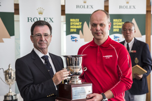 A crew member from Ambersail collects the Polish Trophy for the yacht travelling from the furthest point to compete