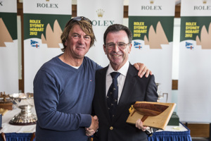 Sean Langman collects the Plum Crazy trophy for the first yacht under 9.5m across the finish line from CYCA Commodore Howard Piggott