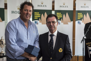 Jason Van der Slot accepts the Apollo Trophy for the first yacht under 18.5m across the finish line