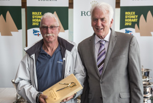 Phil Brassington, navigator of Cougar II, accepts the City of Hobart trophy for the Navigator of the first Tasmanian yacht on corrected time, from Damon Thomas, Lord Mayor of Hobart