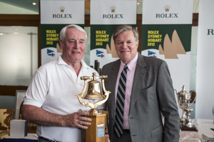 Lindsay May, navigator, Love & War, accepts the Tasports trophy for first ORCi Div 3, from Paul Weedon, Chairman, TasPorts