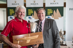 Roger Hickman, owner Wild Rose, accepts the Sir Arthur Warner Trophy for first IRC Division 4, from Paul Weedon, Chairman, TasPorts