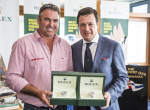 John Hildebrand, Wild Oats XI, is presented with two Rolex Yacht-Master timepieces, for Wild Oats XI's line honours and overall win, by Patrick Boutellier, General Manager, Rolex Australia
