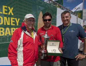 Bob Oatley, owner of Wild Oats XI, skipper Mark Richards accepting the JH Illingworth Trophy from Richard De Leyser, General Manager, Rolex Australia