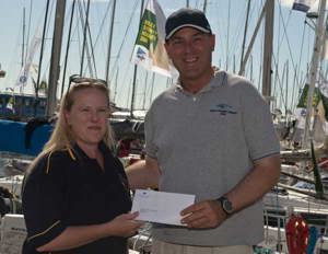 Angela Matthews, Secretary, St Helens Marine receiving the CYCA SOLAS pledge of $20,000 from Commodore Matt Allen, Chairman of CYCA SOLAS Trusts