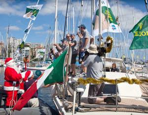 Santa Claus arrives via tender to visit the Italian crew of Onelife