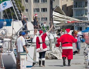 Santa Claus walking the CYCA Marina to visit the crew of Dawn Star